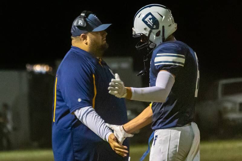 Drew Overocker of Fieldcrest, high-fives coach after scoring touchdown on Friday, September 20, 2024 at Fieldcrest high school in Minonk.