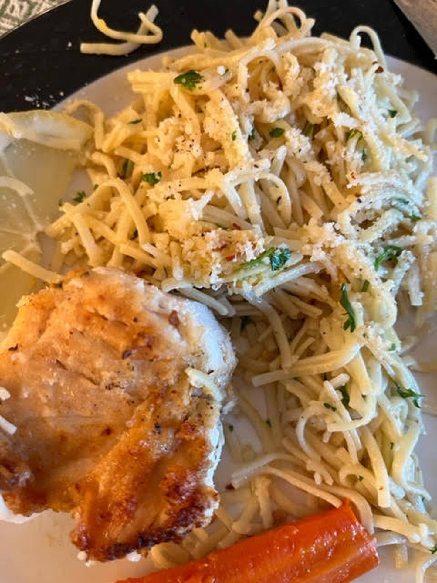 Main course of lemon chicken breast, homemade pasta and stacked veggies, prepared and served by Rita Imgmanson.