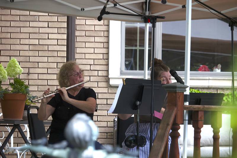 Members of the Joliet Symphony Orchestra play flutes in the 600 block of Western Avenue in Joliet as part of the Porch and Park Music Fest on Saturday, Aug. 16, 2025.