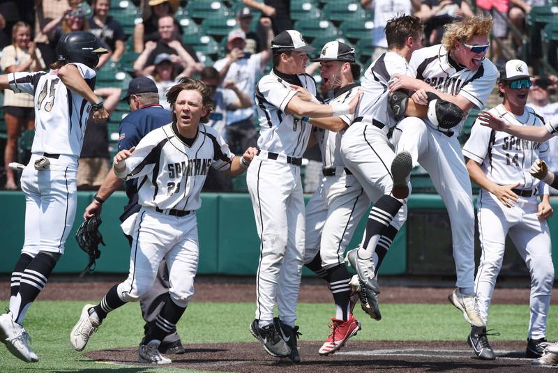 Joe Lewnard/jlewnard@dailyherald.com
Sycamore players celebrate after defeating Effingham 2-1 in nine innings during the Class 3A  third-place state baseball game in Joliet Saturday.