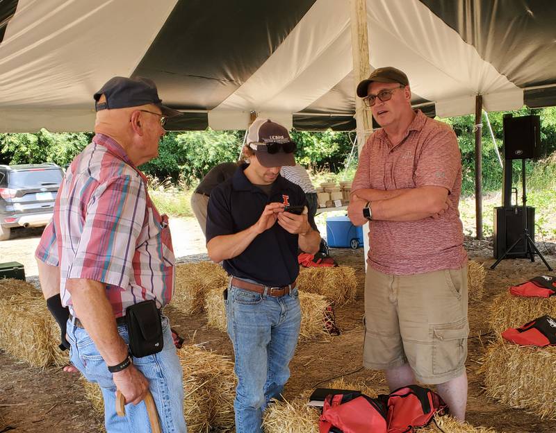 University of Illinois soil scientist Andrew Margenot (center) talks with farmers about ongoing cover crop research that he is working on. (Photo by Raelynn Parmely, Illinois Farm Bureau environmental program manager)