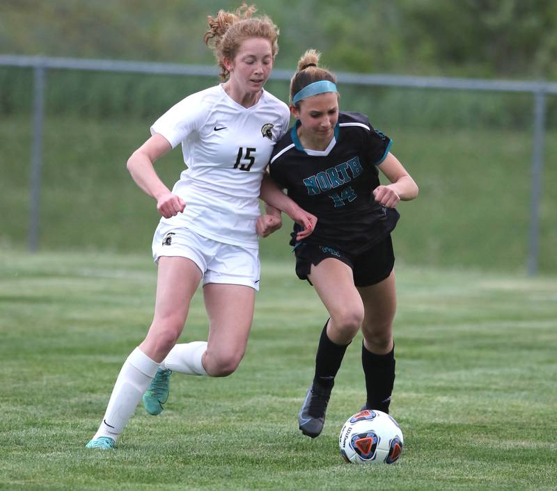 Woodstock North's Stella Splendoria tries to hold off Sycamore's Jordyn Tilstra during their IHSA Class 2A regional game Tuesday, May 17, 2022, at Burlington Central High School.