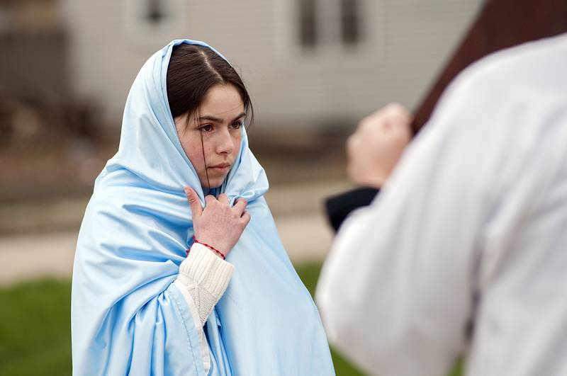 Playing the part of the Mother Mary, the mother of Jesus, Adamari Gutierrez is present during station four where Jesus meets his mother on Friday in Sterling.