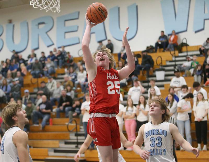 Hall's Wyatt West eyes the hoop while running past Bureau Valley's Elijah Endress and Landon Hulsing on Friday, Jan. 19, 2024 at Bureau Valley High School.