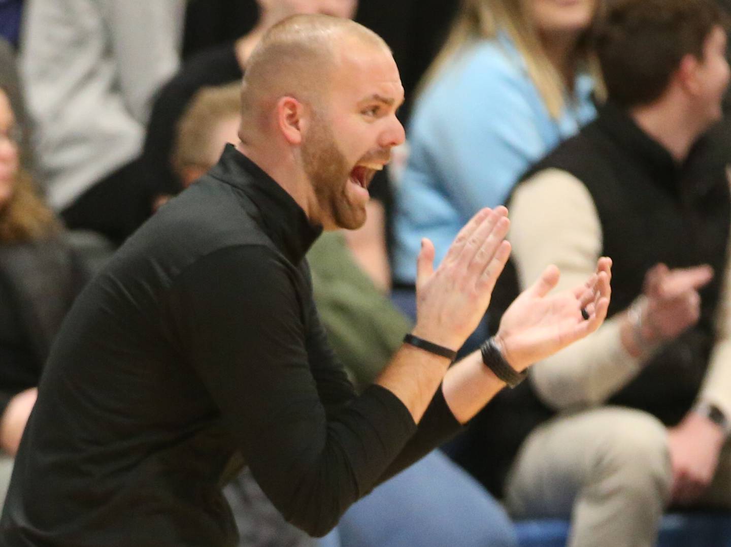 Woodland head boys basketball coach Connor Kaminke cheers on his team while playing Fieldcrest on Tuesday, Dec. 19, 2023 at Fieldcrest High School.