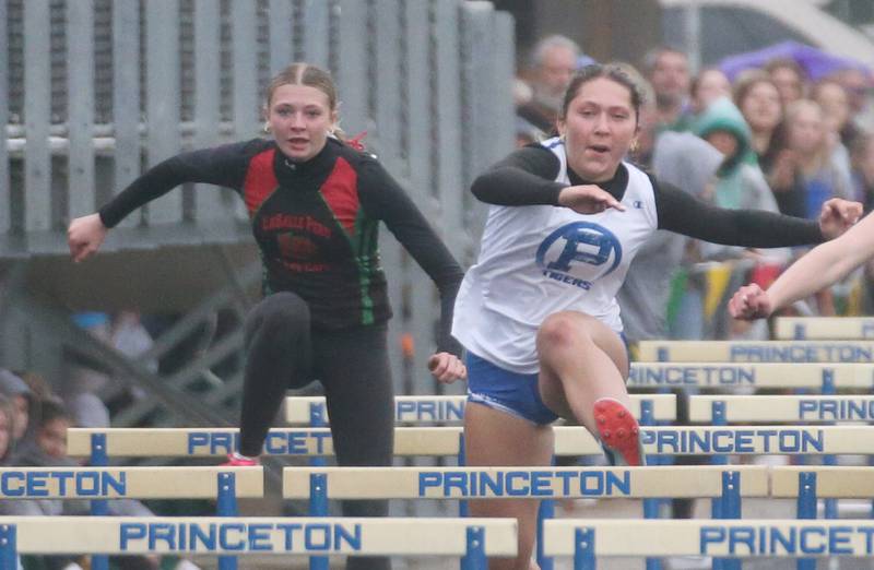 L-P's Dubrey Duttlinger and Princeton's Miyah Fox compete in the 100 meter hurdles during the Class 2A girls track and field Sectional on Thursday, May 9, 2024 in Princeton.