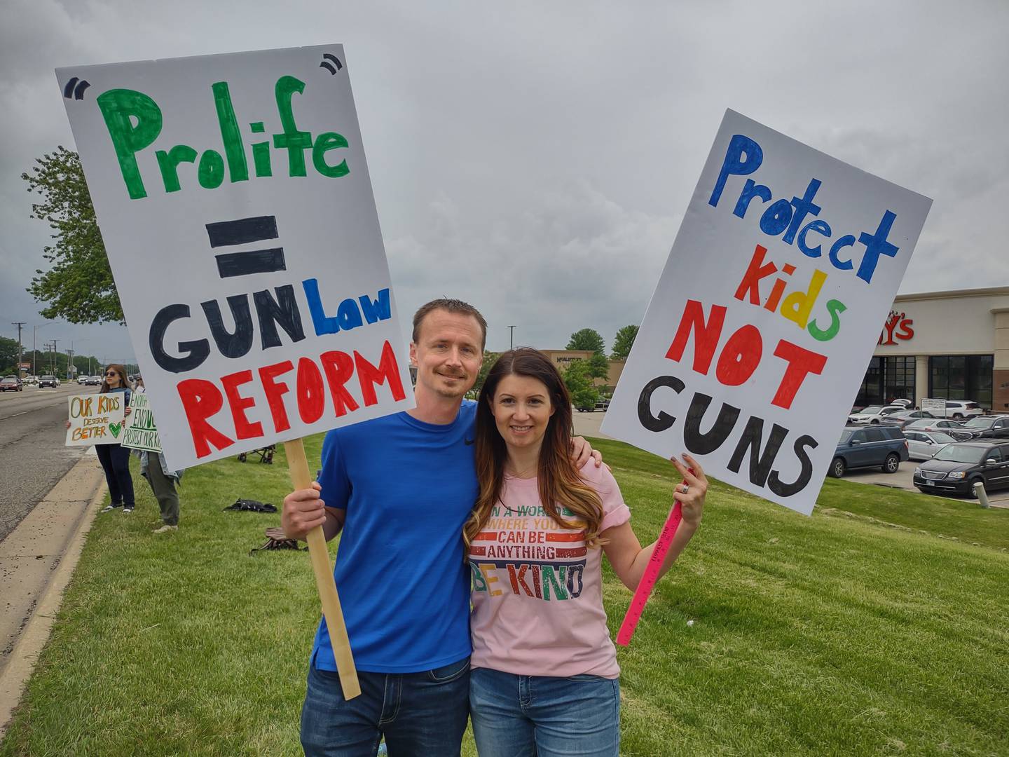 Don and Jessica Gregory pose with their signs during a March for Our Lives rally Saturday afternoon in Crystal Lake. Dozens of McHenry County and Crystal Lake residents, including teachers, parents, local officials, and kids, lined Route 14 to protest inaction on gun safety in the wake of the Uvalde massacre.