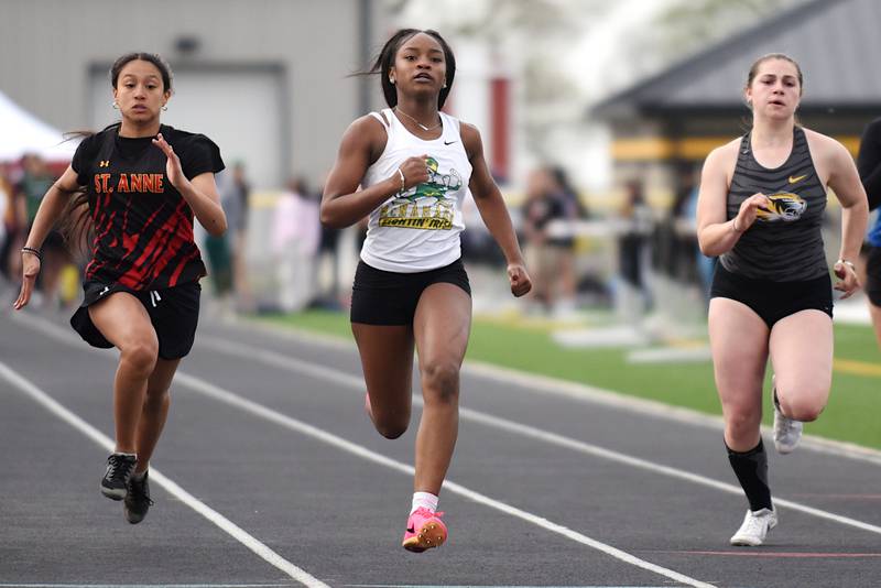 From left, St. Anne's Jayla Smith, Bishop McNamara's Amiah Wynn and Herscher's Taylor Foltz run the 100 m dash at the Herscher Invite Friday, May 2, 2025.