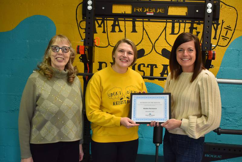 Judy Booze (Streator Chamber ambassador) and Courtney Levy (Chamber executive director) present the Streator Chamber's Business of the Month award for December 2023 to , Courtney Jonnson, owner of Maiden Resistance.