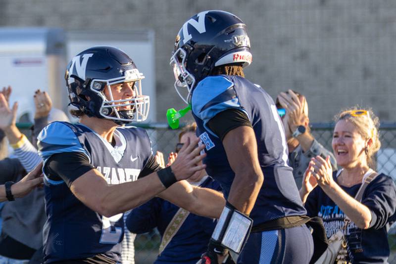 Nazareth's Jackson Failla celebrates with Trenton Walker the game-winning touchdown during Saturday's Class 6A quarterfinal with Lake Zurich.