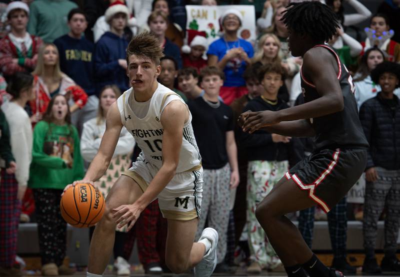 Bishop McNamara's Coen Demack makes a break toward the net as Chicago Bull Prep's Marqwon Haggard, right, guards in a game on Friday, December 19, 2025.