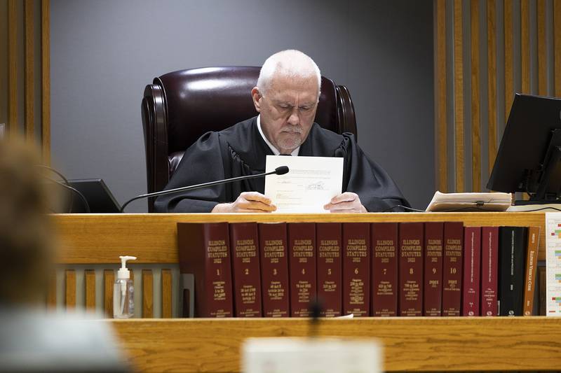 Whiteside County Circuit Court Judge James Heuerman looks over a form Wednesday, March 19, 2025, during a pretrial conference for Kyle Cooper.