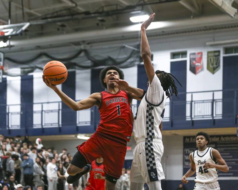 Bolingbrook's Brady Pettigrew (1) puts in a basket during their basketball game between Bolingbrook at Oswego East Friday, Jan 30, 2026 in Oswego.