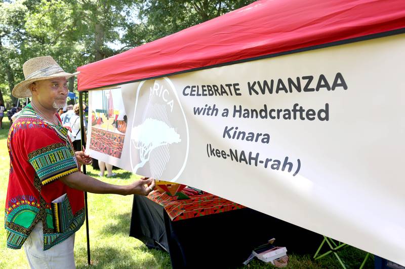 Jim Bailey, of DeKalb, gets his booth ready for visitors during the second annual Juneteenth celebration Sunday, June 19, 2022, at Hopkins Park in DeKalb.