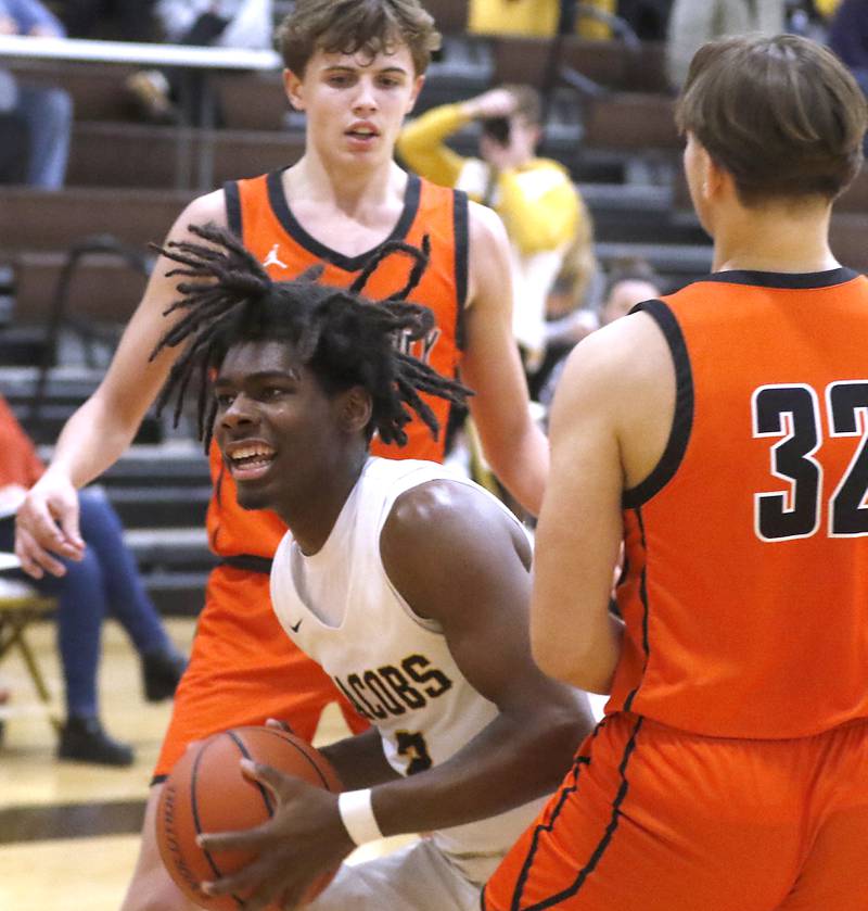 Jacobs' Treval Howard drives to the basket between McHenry's Caleb Jett and Adam Bronowicki during a Fox Valley Conference boys basketball game on Wednesday, Nov. 29, 2023, at Jacobs High School in Algonquin.
