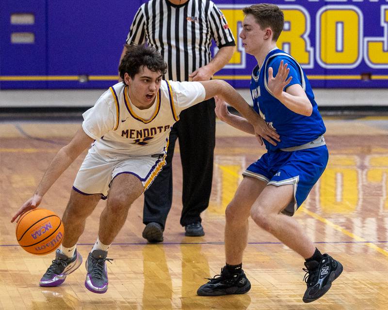 Mendota's Cayden Taliani (12) dribbles ball past Tim Papoccia (11) of Newman Central Catholic on Friday, January 30, 2026 at Mendota High School in Mendota.