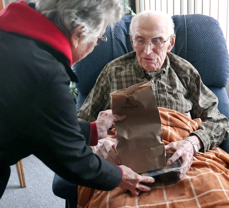 Colette Theurer, a driver with the Voluntary Action Center, delivers a meal to 102-year-old Wilbur Kocher, Thursday, Nov. 17, 2022, at his home in Sycamore. VAC delivers meals to the homebound and elderly along with providing transportation options.