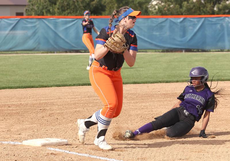 Genoa-Kingston's Elizabeth Davis records a force out at third as Rockford Lutheran's Ja'maya Hawkins slides in during their Class 2A Regional quarter final game Monday, May 15, 2023, at Genoa-Kingston High School.