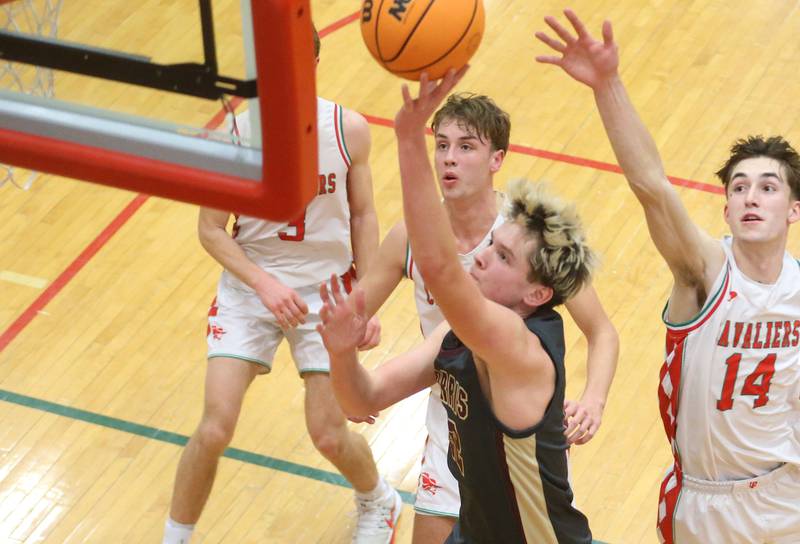 Morris's Hayden Macdonald drives to the hoop in front of L-P's Jameson Hill and Wyatt Kilday on Monday, Feb. 9, 2026 in Sellett Gymnasium at L-P High School.