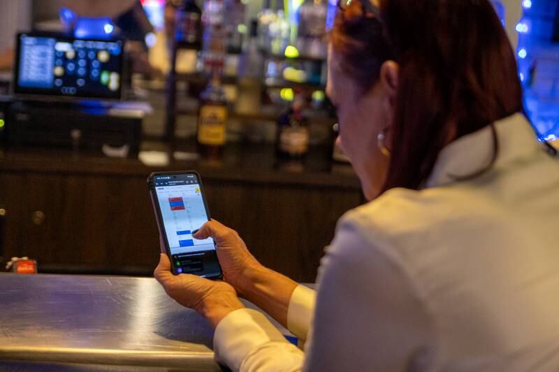State Representative Candidate Amy “Murri” Briel checks live poll results on Tuesday, November 5, 2024 at Alfano’s in Ottawa.