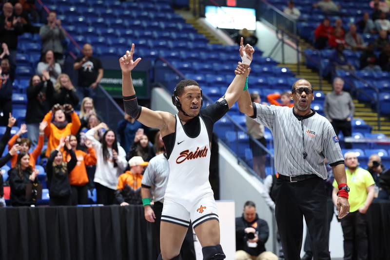 St. Charles East's Isaac Lenard celebrates his 157-pound win to secure the IHSA Class 3A Dual Team State third place victory over Oak Park-River Forest on Saturday, Feb. 28, 2026.