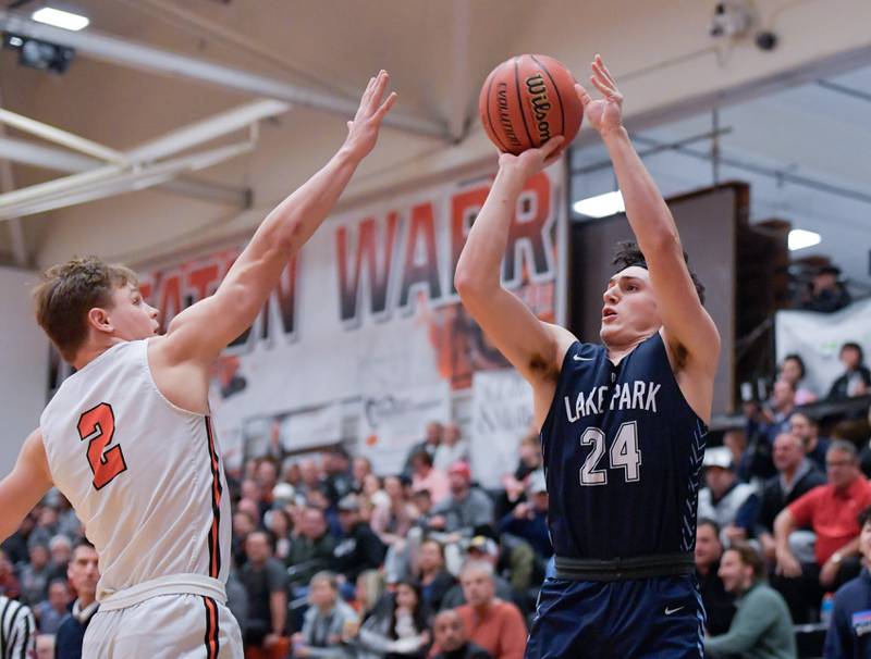 Lake Park's Dennasio LaGioia (24) takes a shot over Wheaton Warrenville South's Jake Vozza (2) during a game on Saturday, Jan. 7, 2023.