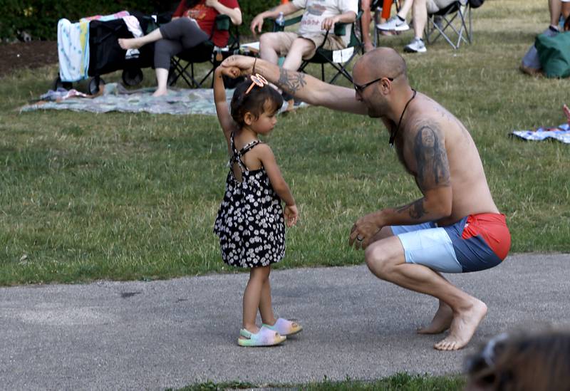 David Kafenshtok dances with his daughter Irie to the the music of Serendipity during the Crystal Lake Park District's Concert in the Park on Tuesday, June 17, 2025, at Main Beach in Crystal Lake. The concert was part of the park district's weekly Tuesday night summer concert series.
