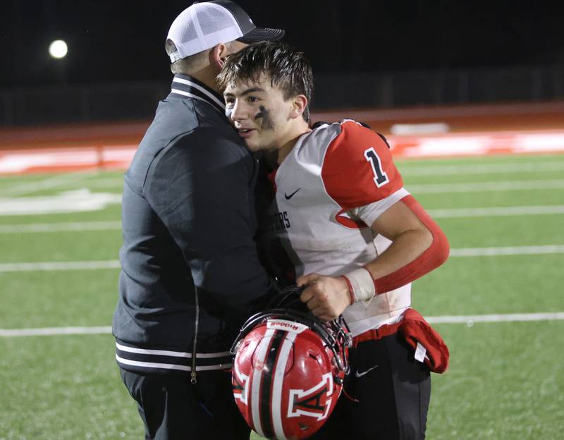 Amboy/LaMoille/Ohio's Jose Lopez, hugs head coach Scott Payne after winning the 8-man I8FA championship game on Friday, Nov. 21, 2025 at April Zorn Memorial Stadium in Monmouth.