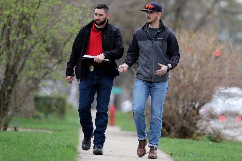 Investigators identifying with the FBI canvass the neighborhood surrounding the Freund residence on Dole Avenue on Monday in Crystal Lake.