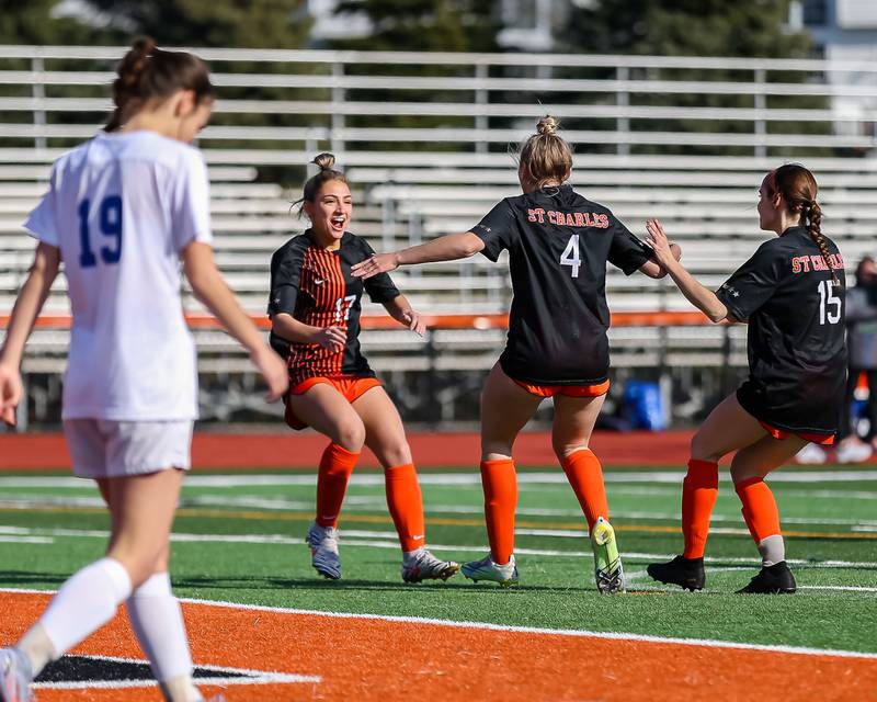 St Charles East's Mia Raschke (17) celebrates a goal with teammate Grace Willams (4) during soccer match between Burlington Central at St. Charles East.  March 28, 2023.