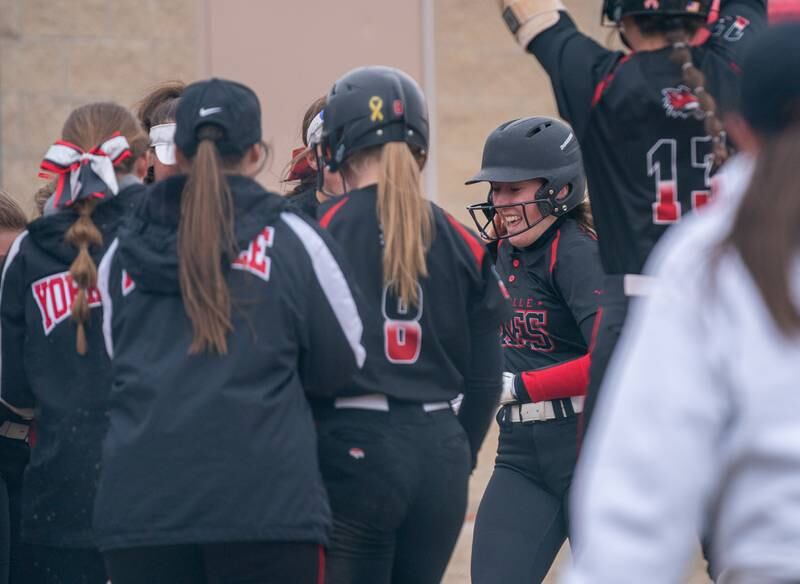 Yorkville's Madi Reeves (2) is greeted at home by her team after hitting a homer against Neuqua Valley during a softball game at Yorkville High School on Wednesday, April 6, 2022.