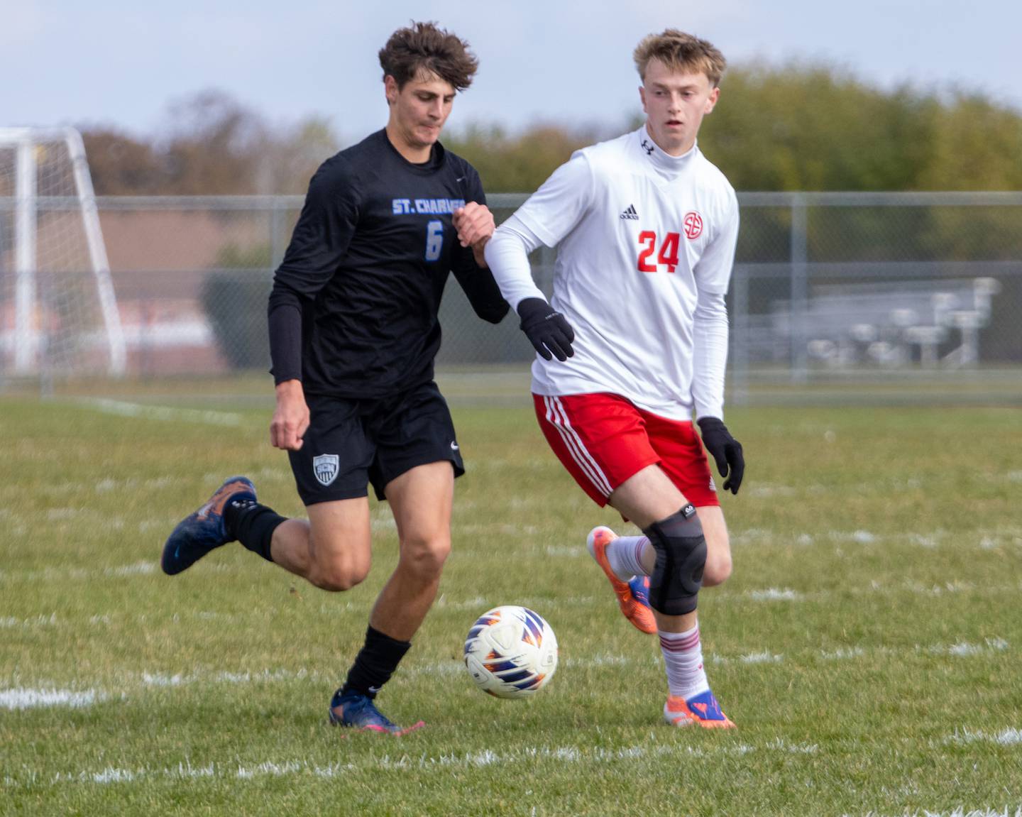 St. Charles North's Dino Valenti looks to advance the ball past South Elgin's Jack Schmidtke at the Class 3A Sectional Final on Saturday, Nov. 1,2025 in South Elgin.