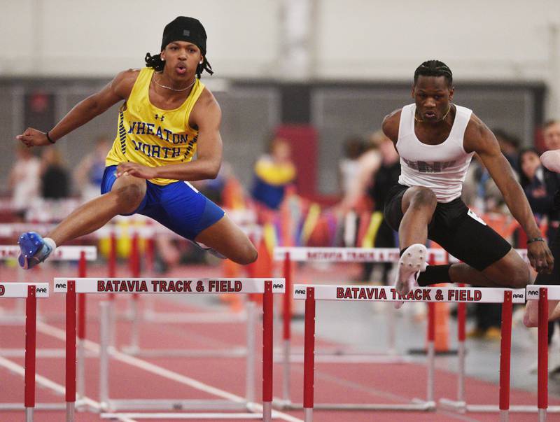 Wheaton North’s Matthew Shelton, left, and Glenbard North’s Jeremiah Williams clear the final hurdle in the 55-meter hurdles during the DuKane Conference indoor track meet at Batavia High School on Friday, March 21, 2025.