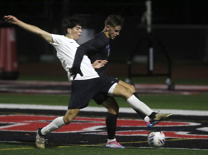 McHenry's Dylan Fischler tries to keep St. Charles North's 	Nolan Schoenholz from controlling the ball during an IHSA Class 3A Huntley Regional boys soccer semifinal match on Tuesday, Oct. 21, 2025, at Huntley High School.