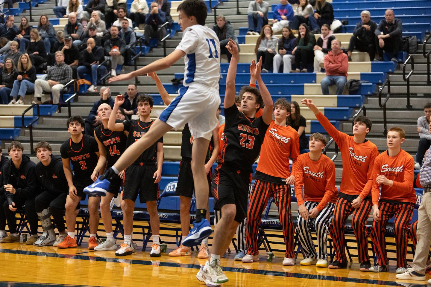 Wheaton Warrenville South's David Showman shots a three pointer over Geneva's Kyle Suger on Wednesday, Dec.10,2025 in Geneva.