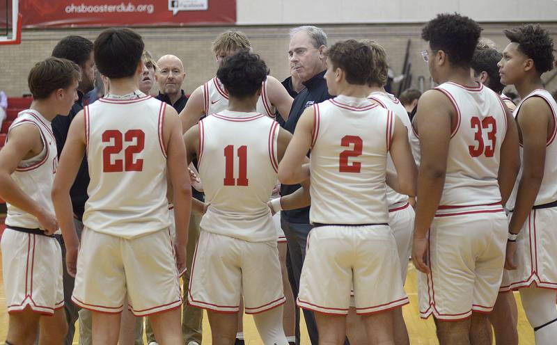Ottawa Head Coach Mark Cooper addresses the team during a timeout after falling behind Sandwich in the 2nd period Tuesday at Ottawa.