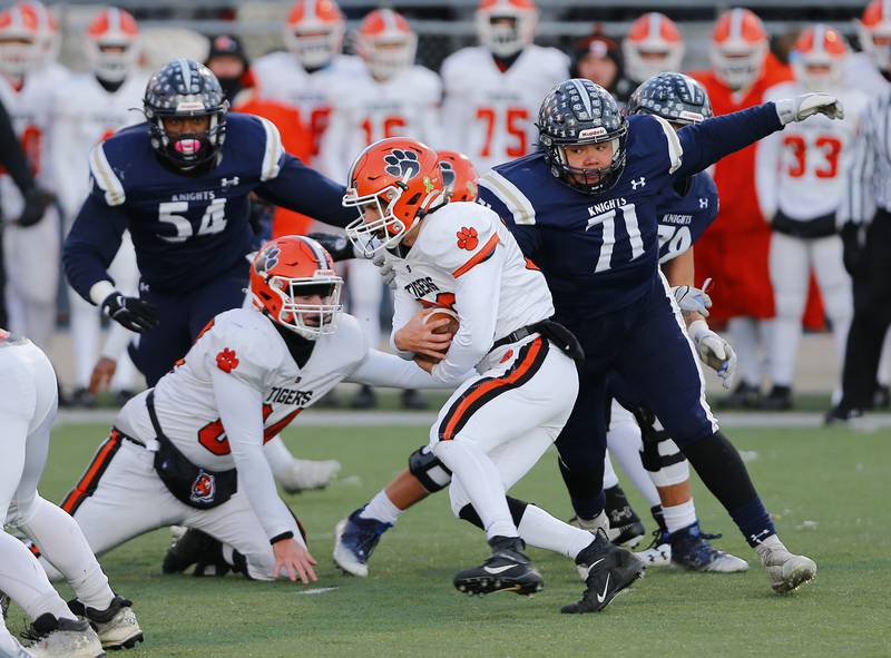 Byron's Kye Aken (29) is chased down by IC Catholic's Isaiah Gozalez (71) during a Class 3A varsity football semi-final playoff game between Byron High School and IC Catholic Prep on Saturday, Nov. 19, 2022 in Elmhurst, IL.