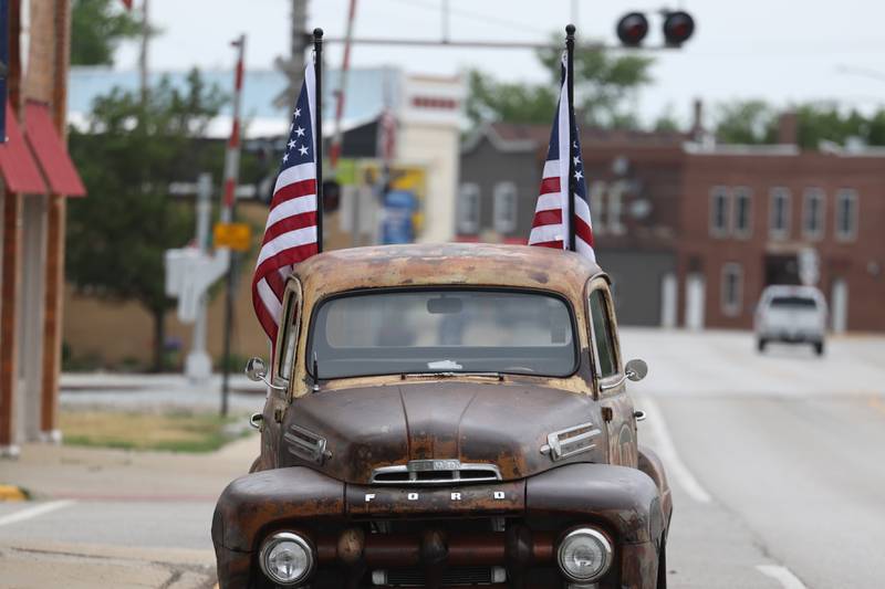 A vintage Ford truck holding two American flags sits along South State Street on Saturday, July 1st, 2023, in Manhattan.