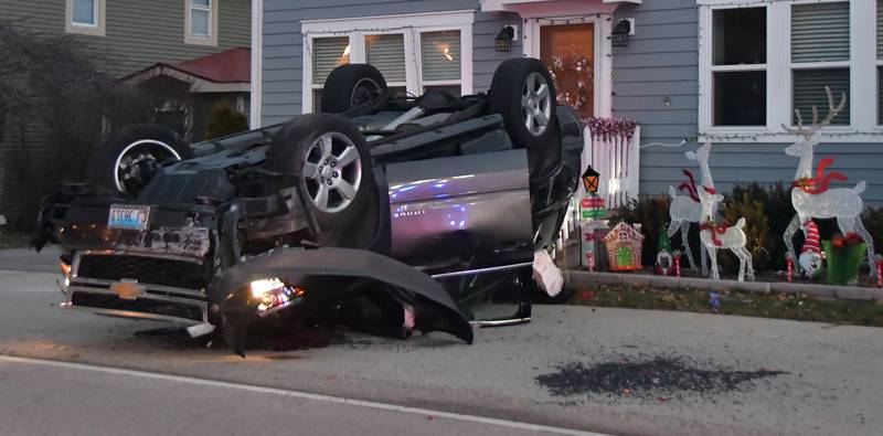 Driver suffers minor injuries after striking a parked car and rolling over into a front yard in Volo Monday morning.
