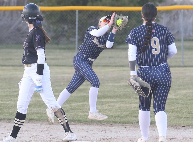 Marquette's Hunter Hopkins (center) makes a catch on the run as Serena's Jenna Setchell looks on while standing on second base on Wednesday, March 26, 2025 at Serena High School.