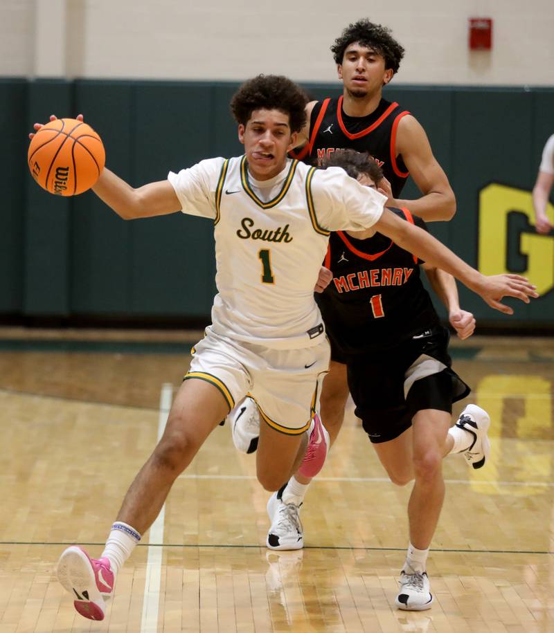 Crystal Lake South's Noah Cook is found bfrom behind by McHenry's Henry Collette as he pushes the ball up the court during a Fox Valley Conference boys basketball game on Wednesday, Jan. 14, 2026, at Crystal Lake South High School.
