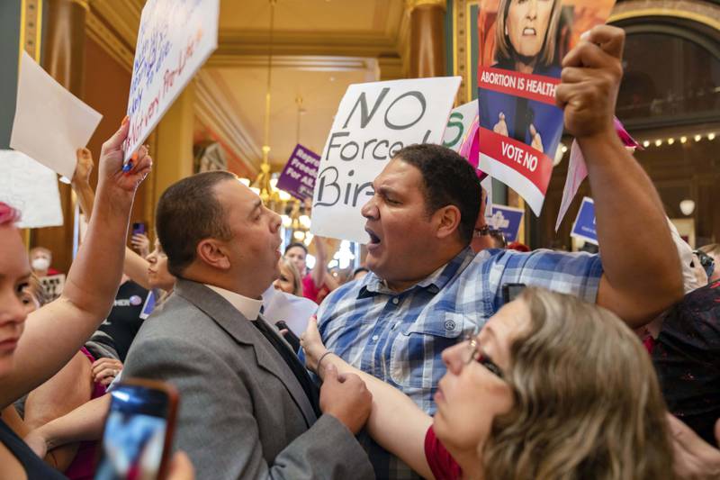 FILE - Pastor Michael Shover of Christ the Redeemer Church in Pella, left, argues with Ryan Maher, of Des Moines, as protestors voice opposition to a new ban on abortion after roughly six weeks of pregnancy introduced by Republican lawmakers in a special session in Des Moines, Iowa, July 11, 2023. The Iowa Supreme Court is expected to weigh in on the state’s temporarily blocked abortion law, which prohibits abortions after about six weeks of pregnancy and before many women know they are pregnant on Friday, June 27, 2024. (Zach Boyden-Holmes/The Des Moines Register via AP, File)