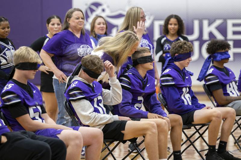 Footballers for Dixon High School get kisses from their moms during a guessing game Friday, Sept. 27, 2024, at Dixon High School. The boys though they were being pecked by a cheerleader.