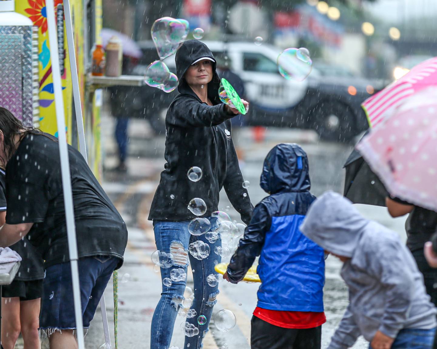 A vendor makes the most of the rain at the Joliet Kidz Fest.  August 5, 2023