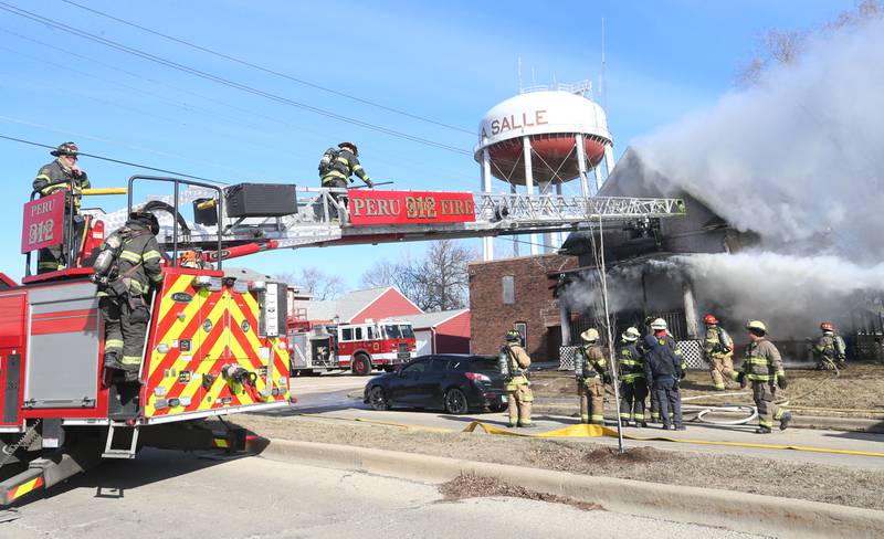 Firefighters work the scene of a fully engulfed house fire in the 800 block of Bucklin Street on Friday, Jan. 23, 2026 in La Salle.