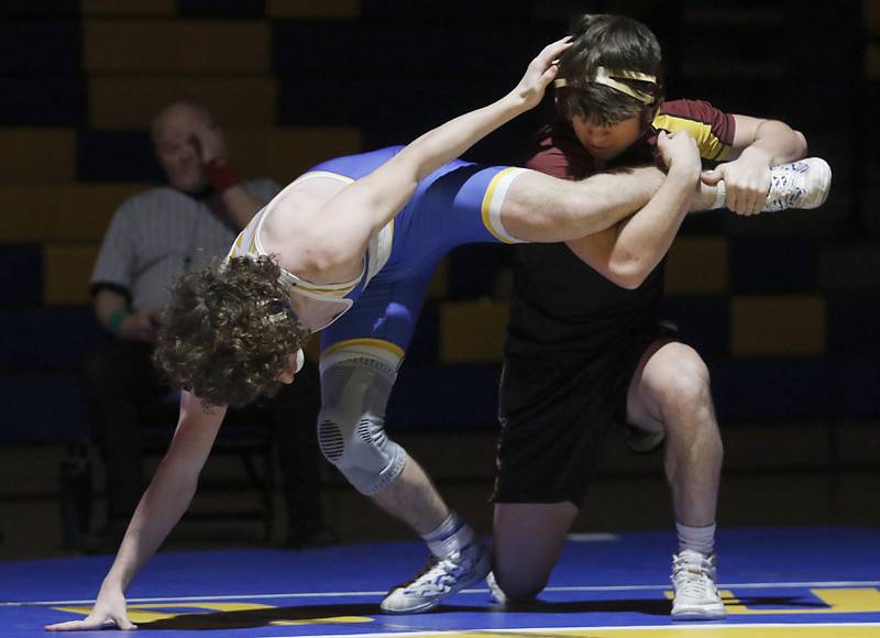 Richmond-Burton’s Emmett Nelson tries to take down Johnsburg’s Josh Key in the 144-pound match of a Kishwaukee River Conference wrestling meet on Thursday, Jan. 30, 2025, at Johnsburg High School.
