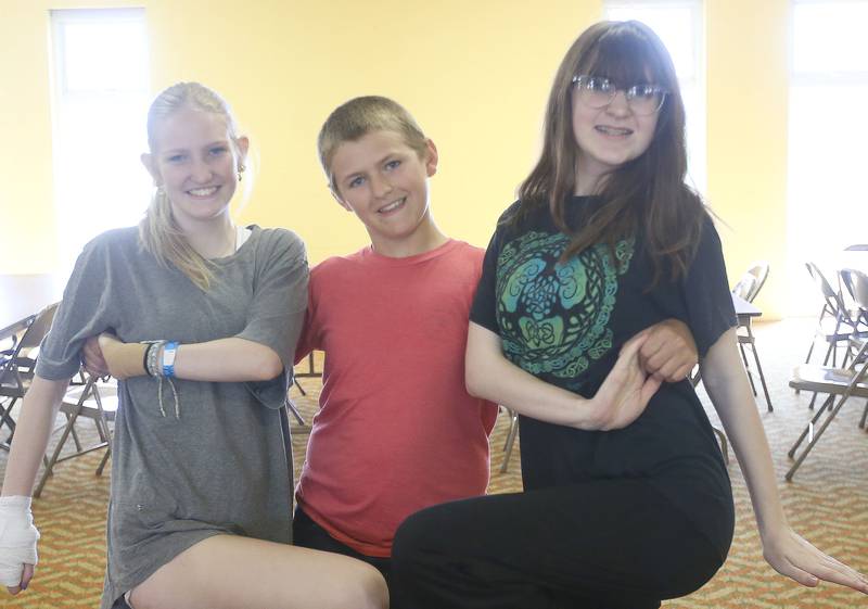 (From left) Alexis Rowe, Jameson Long an Kira Roberts  rehearse a scene for the upcoming musical Annie Jr. on Tuesday, June 24, 2025 at the First United Methodist Church in Henry. The show will be presented July 25-27 at the River Valley Players theater in Henry, .