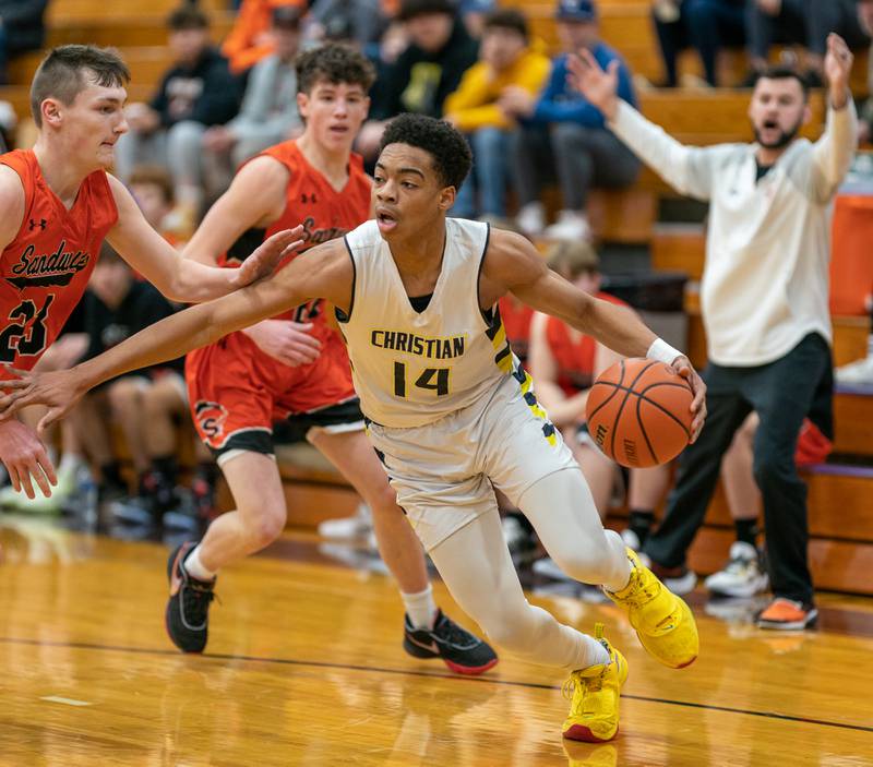 Yorkville Christian's David Douglas Jr (14) drives to the basket against Sandwich’s Chance Lange (23) during the 59th Annual Plano Christmas Classic basketball tournament at Plano High School on Tuesday, Dec 27, 2022.