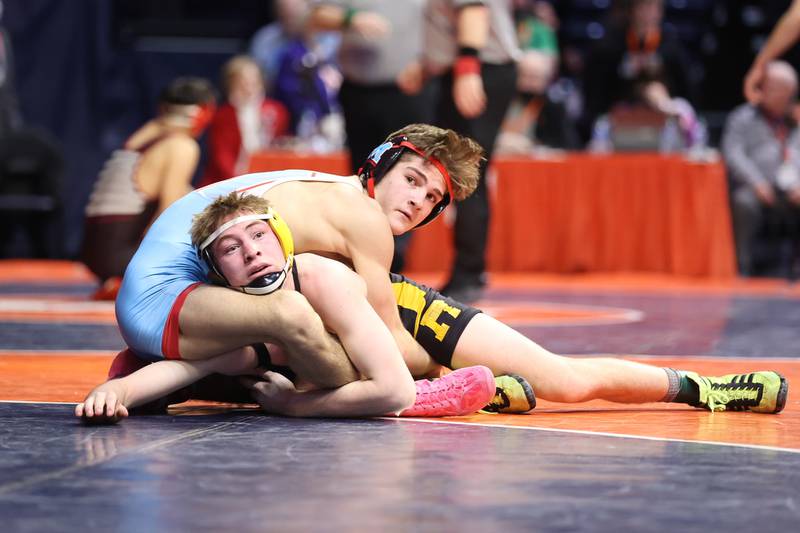 Riverdale’s Brock Smith (bottom) and Marian Central’s Vance Williams both check the clock in the Class 1A 132lb. semifinals at State Farm Center in Champaign. Friday, Feb. 18, 2022, in Champaign.