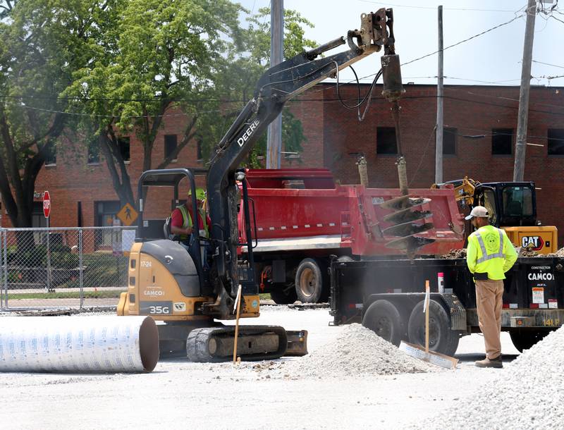 Crews from CAMCO Construction work on paving a lot at the corner of 7th and West Street on Monday, July 7, 2025 at OSF St. Elizabeth West Hospital in Peru.